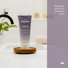 Cremo shaving cream on hand showing rich foam for gentle prep.