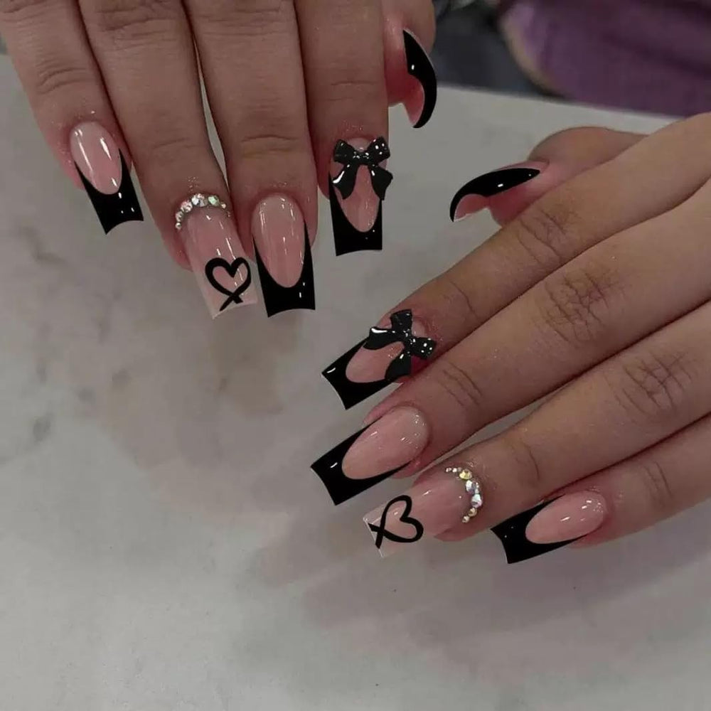 CTTHNBD medium coffin nails in black French tip with bow charms for a chic party look