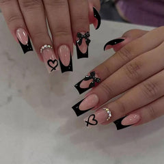 CTTHNBD medium coffin nails in black French tip with bow charms for a chic party look