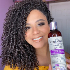 Aqua Gel being dispersed onto curly hair for even distribution