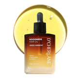 D'Cherlane hair growth oil bottle pour for quick, non-greasy scalp nourishment.