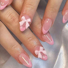 DAJIJIYOU 24-piece French tip nails with almond shape and bow charms for a quick manicure