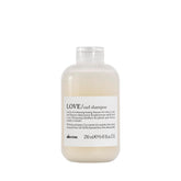 Davines LOVE Curl Shampoo bottle on bathroom shelf for curl definition.