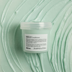 MELU texture close-up reveals creamy emollience for dry ends.