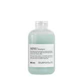 Davines MINU shampoo bottle highlights color protection benefit.