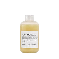 Davines NOUNOU shampoo bottle pour demonstrates gentle cleansing for damaged hair.
