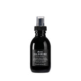 Davines OI All-In-One Milk bottle pour highlights easy detangling and shine.