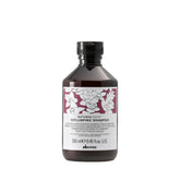 Davines Replumping Shampoo bottle-front with rich foam signaling elasticity
