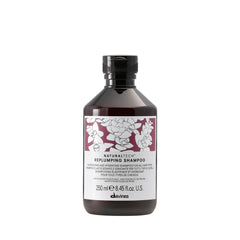 Davines Replumping Shampoo bottle-front with rich foam signaling elasticity