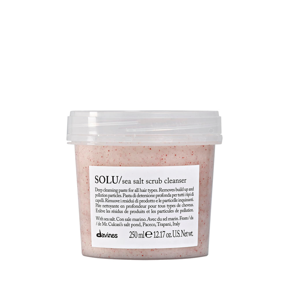 Davines SOLU sea salt scrub cleanser bottle close-up, highlighting cleansing action for the scalp.