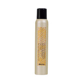 Davines This Is A Dry Wax Finishing Spray for controlled undone texture.