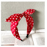 Deghew red polka dot bow headband closeup highlighting vivid color and soft fabric