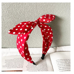 Deghew red polka dot bow headband closeup highlighting vivid color and soft fabric