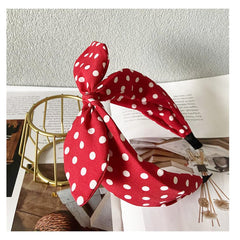 Deghew red polka dot bow headband worn with a retro outfit
