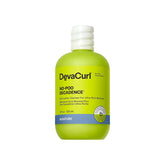 DevaCurl No-Poo Decadence bottle on green oasis, delivering ultra-rich moisture for dry curls.