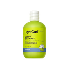 DevaCurl No-Poo Decadence bottle on green oasis, delivering ultra-rich moisture for dry curls.