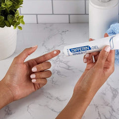 Differin gel tube top view highlights compact, travel-friendly acne solution.