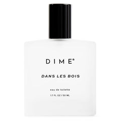DIME Dans Les Bois bottle front shows woody-floral scent for daily wear