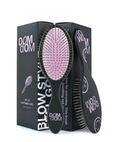 Dom Dom detangling brush with drainage hole for fast drying after shower.