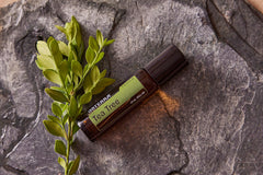 doTERRA Melaleuca Touch roll-on applied to skin for gentle irritation relief