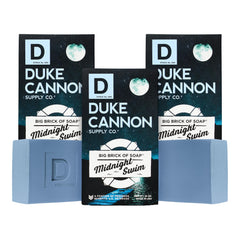 Duke Cannon Midnight Swim soap bar close-up showing a rich lather for daily cleansing.