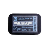 Duke Cannon Midnight Swim solid cologne bottle ready for on-the-go freshness.