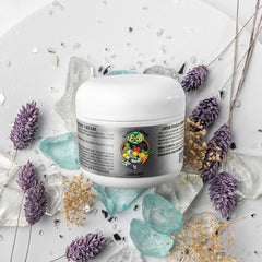 Close-up of E de B Essence cream being applied to skin for nourishment.