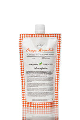 Ecoslay Orange Marmalade bottle pour demonstrating easy, mess-free application for defined curls.