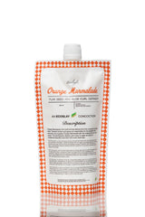 Ecoslay Orange Marmalade bottle pour demonstrating easy, mess-free application for defined curls.