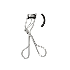 Using the e.l.f. eyelash curler to lift lashes before mascara.