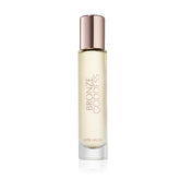 Estee Lauder Bronze Goddess Eau Fraiche bottle glows in warm light, great for daytime radiance.