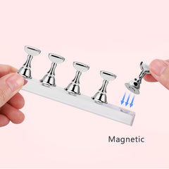 Etercycle nail stand double-sided tape secures nails for precise designs.
