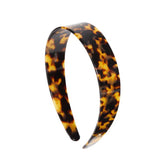 EVITA PERONI wide headband close-up shows glossy acetate for gentle wear