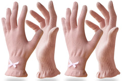 Evridwear pink overnight moisturizing gloves resting beside a nightstand