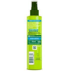 Hands applying Garnier Fructis Pure Moisture to damp hair