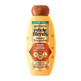 Garnier Whole Blends Reparando Miel Tesoros: botella de champú con fragancia miel que nutre y fortalece cabello dañado.