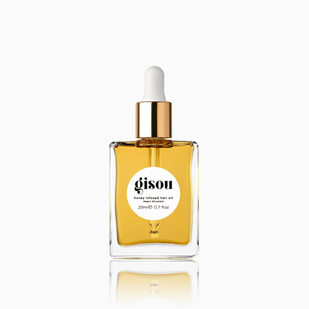 Gisou Honey Infused Hair Oil Mini bottle close-up showing hydration-ready shine.