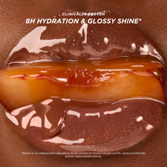Gisou Honey Infused Lip Oil on lips provides a luminous finish.