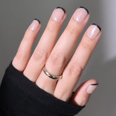 Glamnetic Burnt Miso nails close-up with bold black tips for a modern manicure.