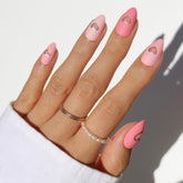 Glamnetic Matte In Love nails close-up showing pink tones and gold heart cutouts for chic daily wear.