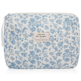 Gosect floral makeup bag closeup features blue floral print and sturdy stitching.