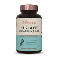 Hair La Vie Live Conscious bottle label highlights vitamins for healthier hair growth.