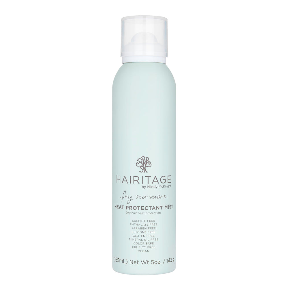 Hairitage spray protector de calor, botella visible protegiendo el cabello.