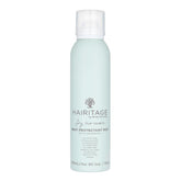 Hairitage spray protector de calor, botella visible protegiendo el cabello.