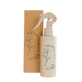 Harmonize Beauty leave-in conditioner bottle showcases frizz control and hydration.