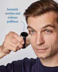 Applying Harry's eye cream under the eyes for a refreshed look.