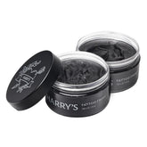 Harry’s Tattoo Frost bottle demonstrates lightweight hydration for vibrant tattoos.
