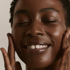 Applying ILIA The Base Face Milk Essence on skin demonstrates easy layering