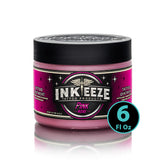 INK-EEZE Pink Tattoo Ointment bottle closeup showing vegan non-petroleum formula for smooth tattooing