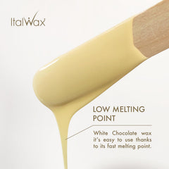 Spatula applying Italwax beads in a warm setup for even coverage.